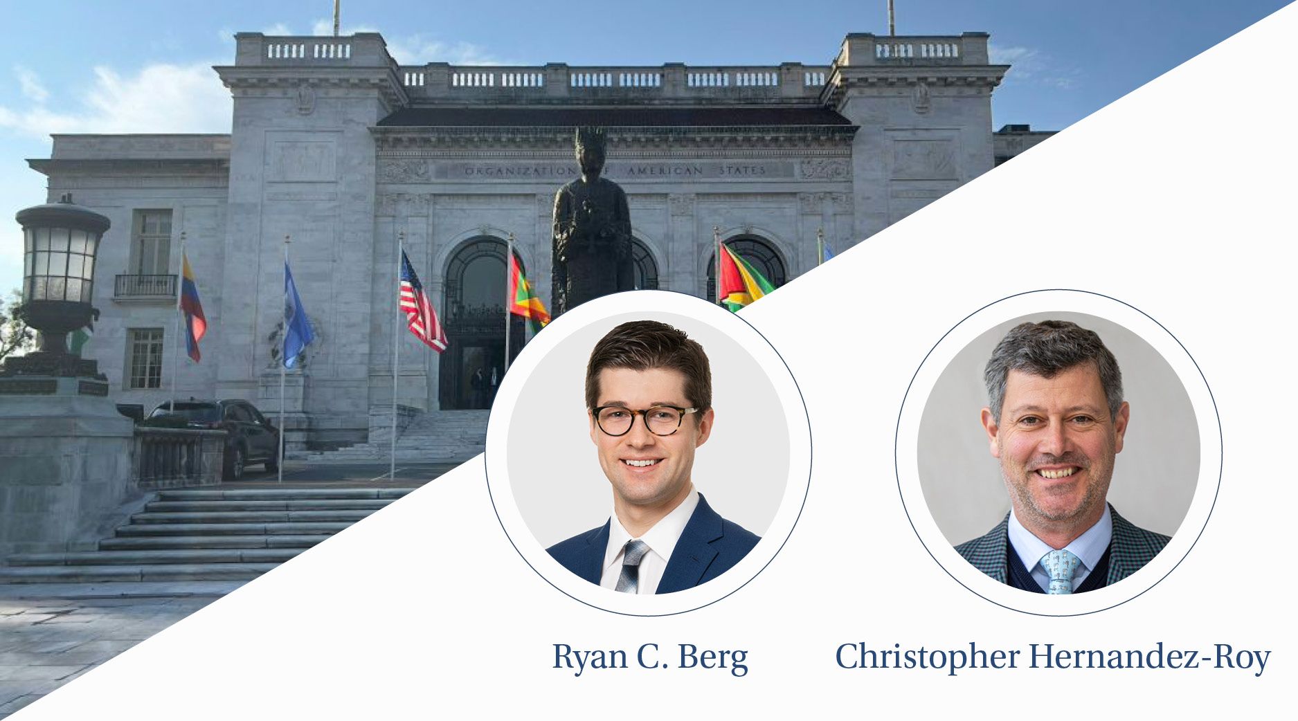 Colorful flags wave in front of a gray building with a dark gray statue.