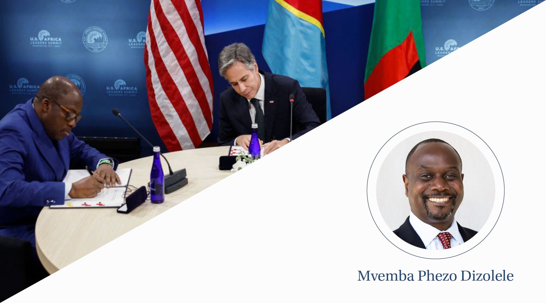 Secretary Blinken signs a document with the foreign ministers of Congo and Zambia in a blue room with flags.