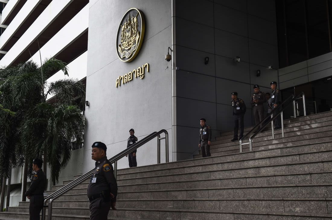 Thai policemen stand guard at a court in Bangkok