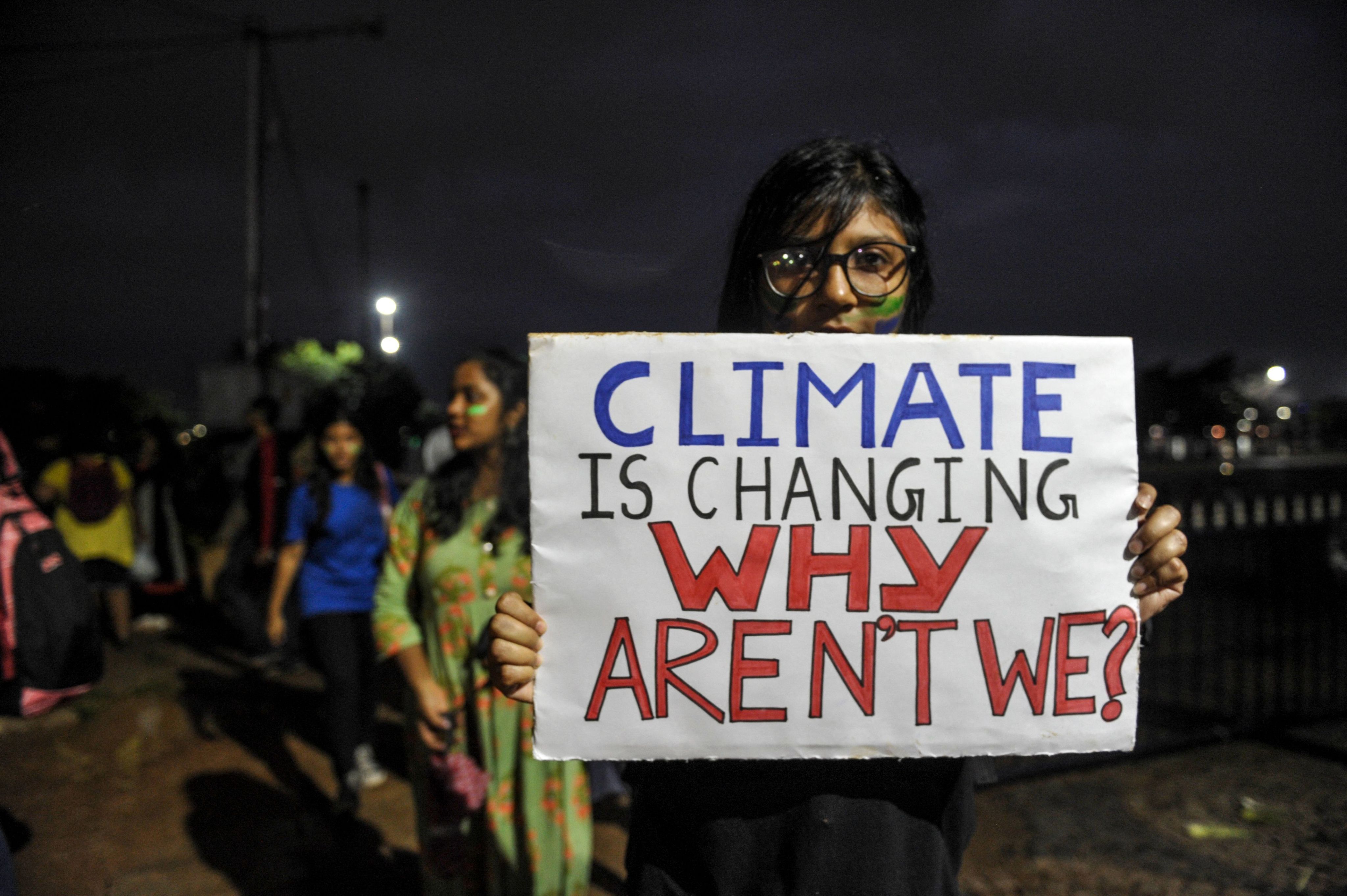 A protestor holds a sign at a climate strike against governmental inaction towards climate breakdown and environmental pollution in Hyderabad, India, in September 2019. | Noah Seelam/AFP via Getty Images