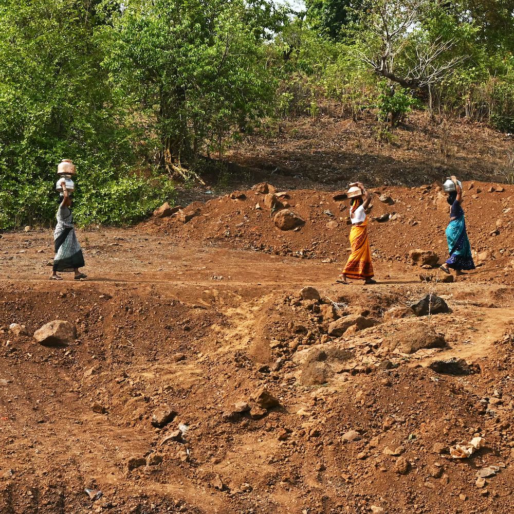 Women gather water in a drought.