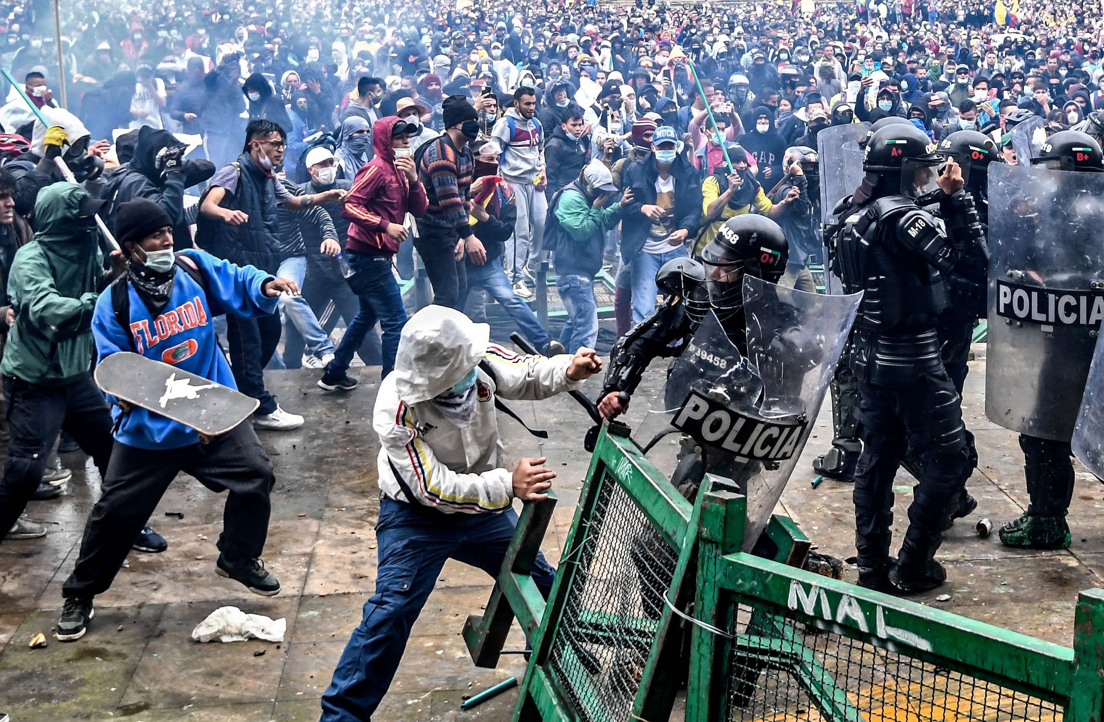 People protesting a tax reform bill proposed by former President Duque clash with riot police in Bogota in April, 2021. 