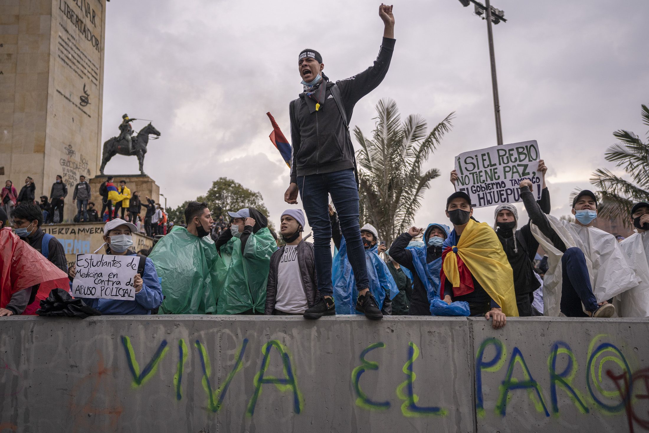Protestors during a national strike in Bogota, Colombia, hold signs and shout slogans in May 2021.