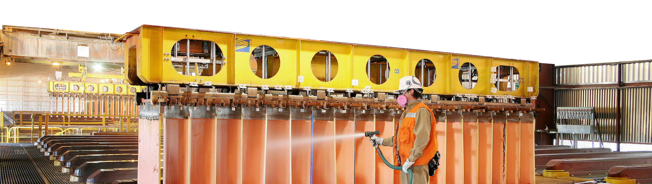 Worker cleaning copper cathodes in Escondidas Electro Winning Shed, Chile.