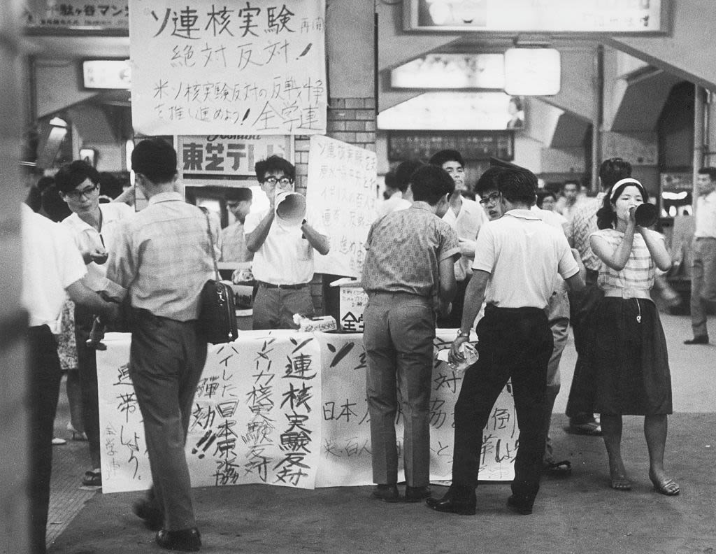 Students demonstrating against nuclear weapons in front of a train station in Tokyo collect signatures in 1963. | Claude Jacoby/Ullstein Bild via Getty Images