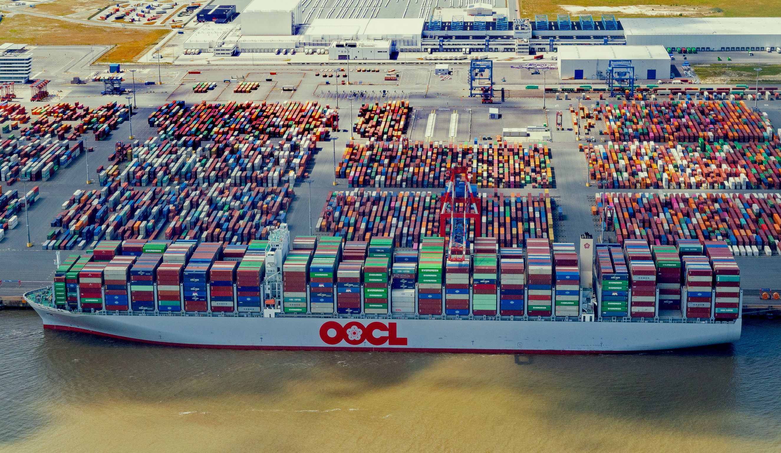 A container ship stands among containers in Wilhelmshaven port on July 16, 2022 in Wilhelmshaven, Germany.