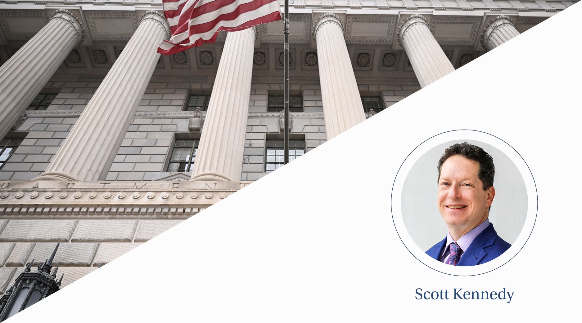 A view of a white marble building with columns with an American flag waving in front.