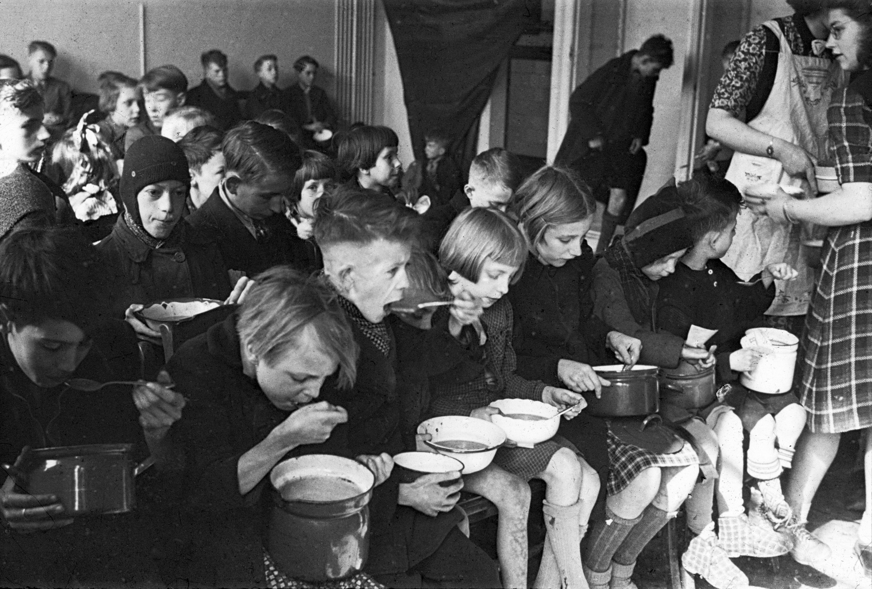 Dutch children eating soup during the famine of 1944–1945
