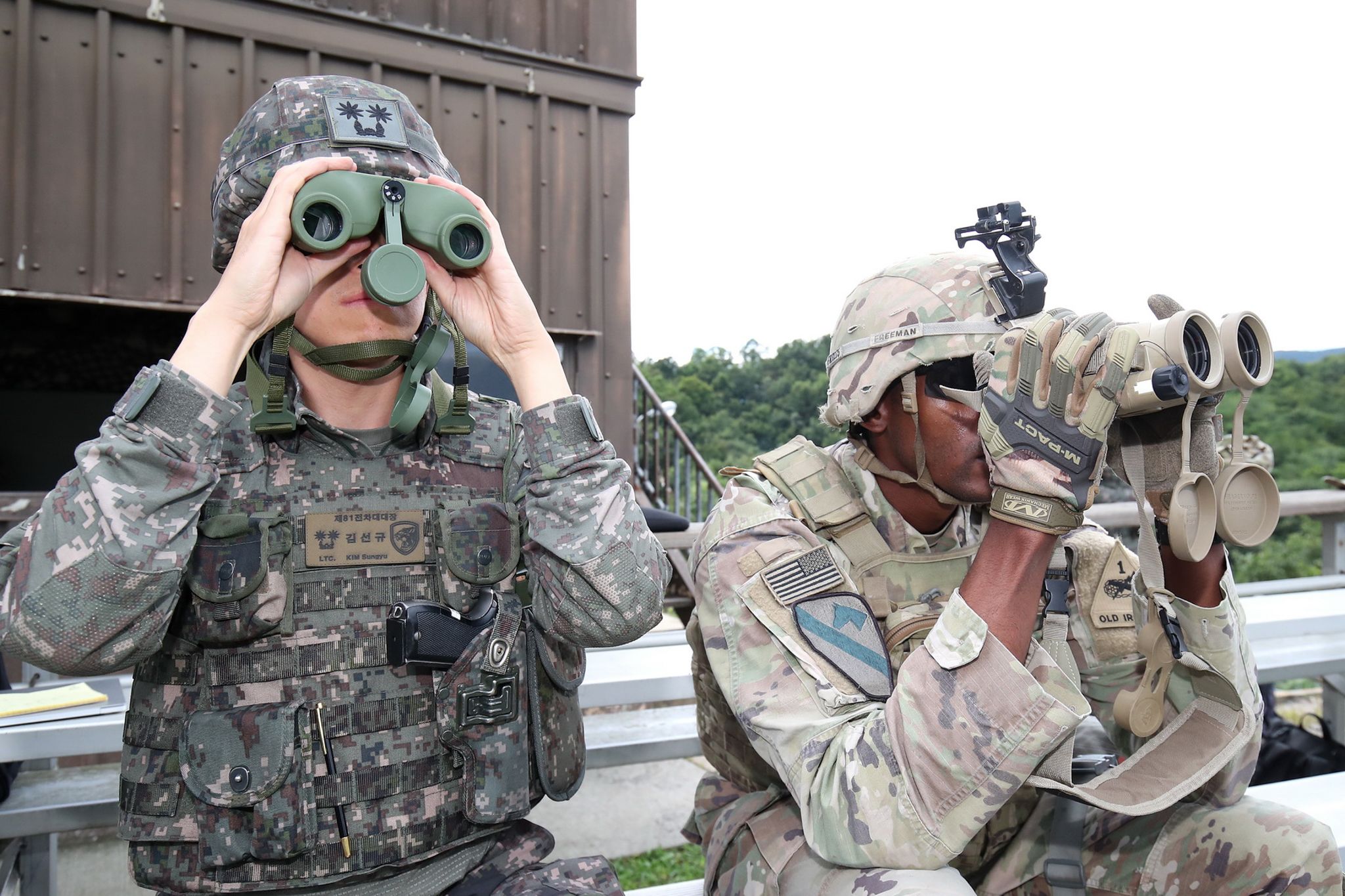 A South Korean and an American soldier look through binoculars during a joint training exercise.