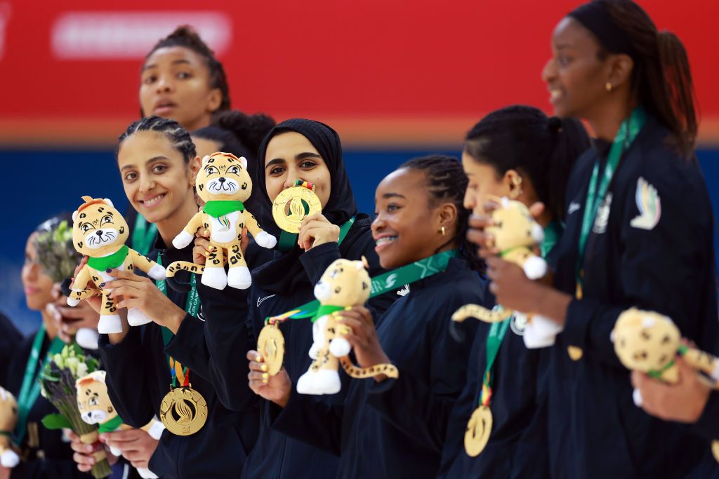 Women holding their medals at the medal ceremony