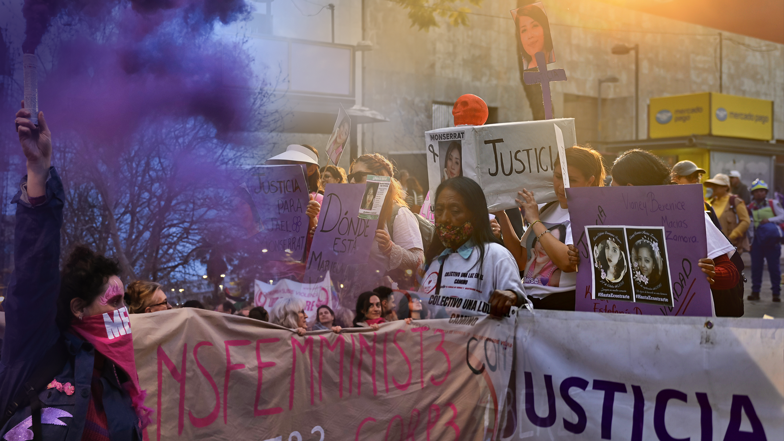 Women protest holding signs with the faces of other women.
