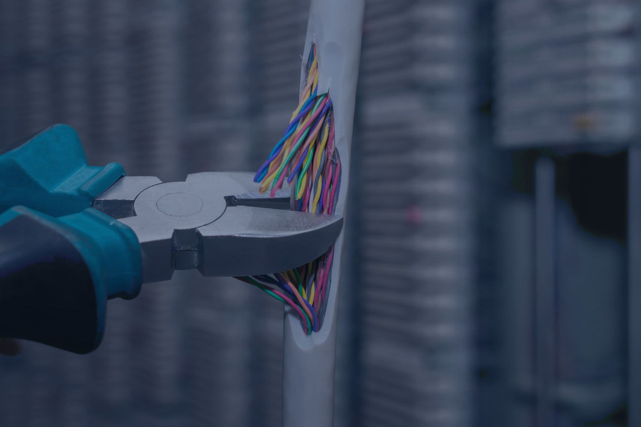 Network internet cable is cut using shears. | Klmax via Getty Images