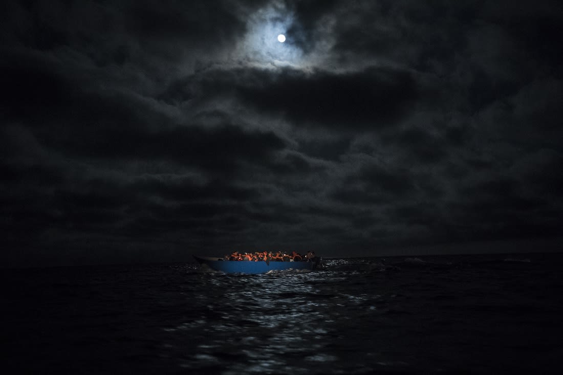 A wooden boat with approximately 100 people of different nationalities on its journey through the Mediterranean to Lampedusa on March 29, 2021. | Photo by Carlos Gil via Getty Images 