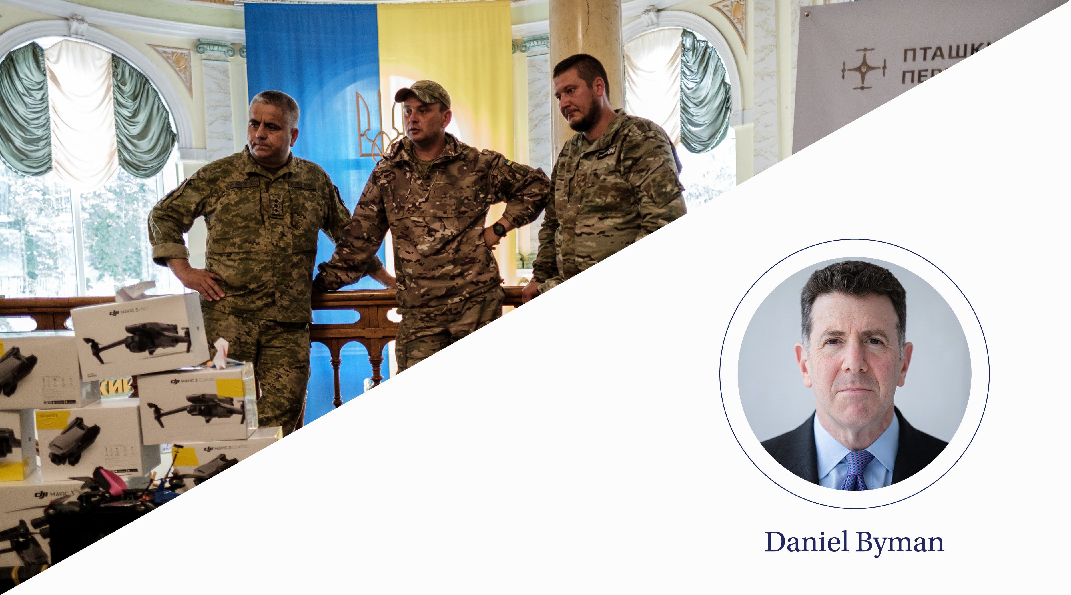 Three men stand with hands on hips behind a pile of boxed robotic equipment.