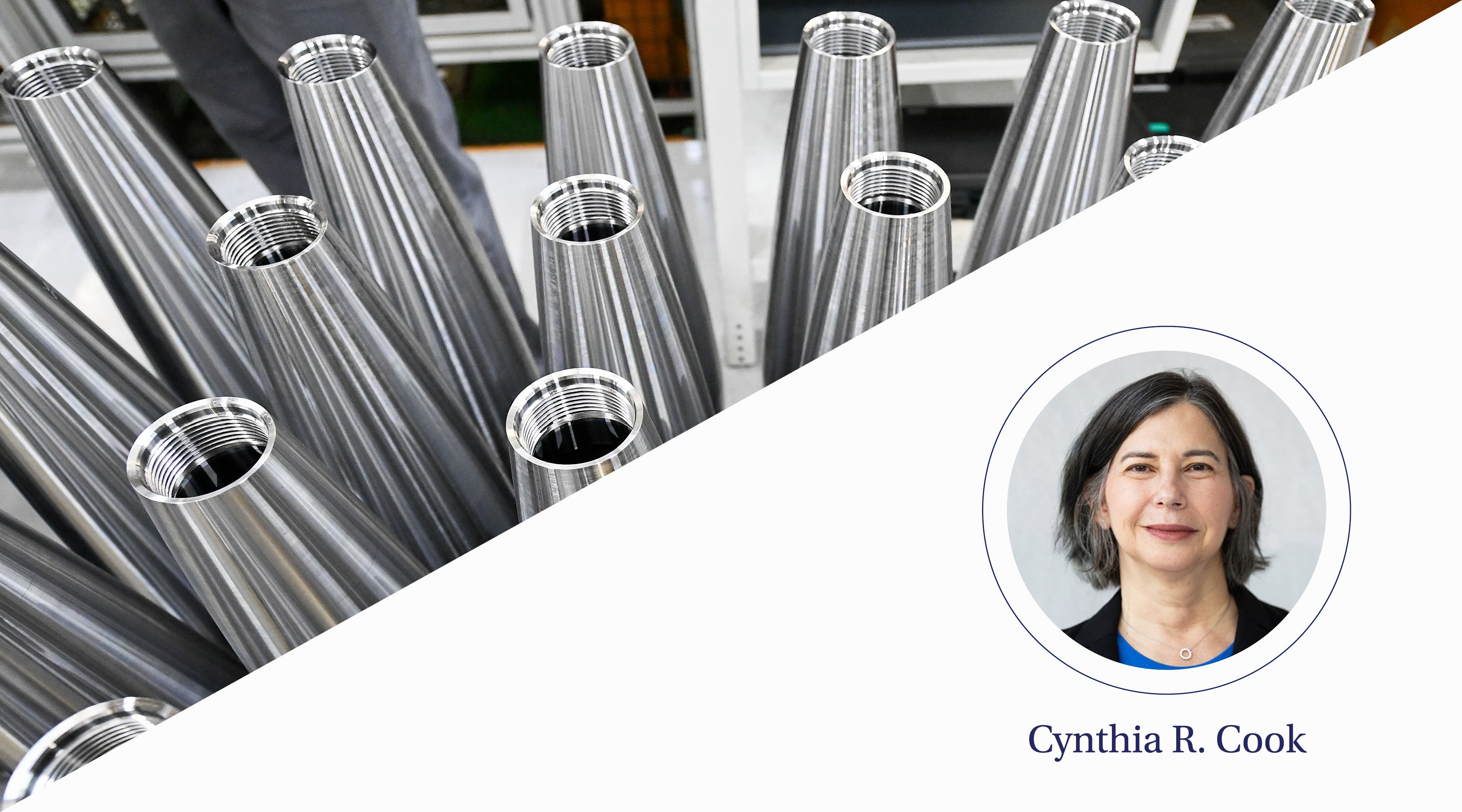 Men in hardhats construct a bamboo structure in a rural area.