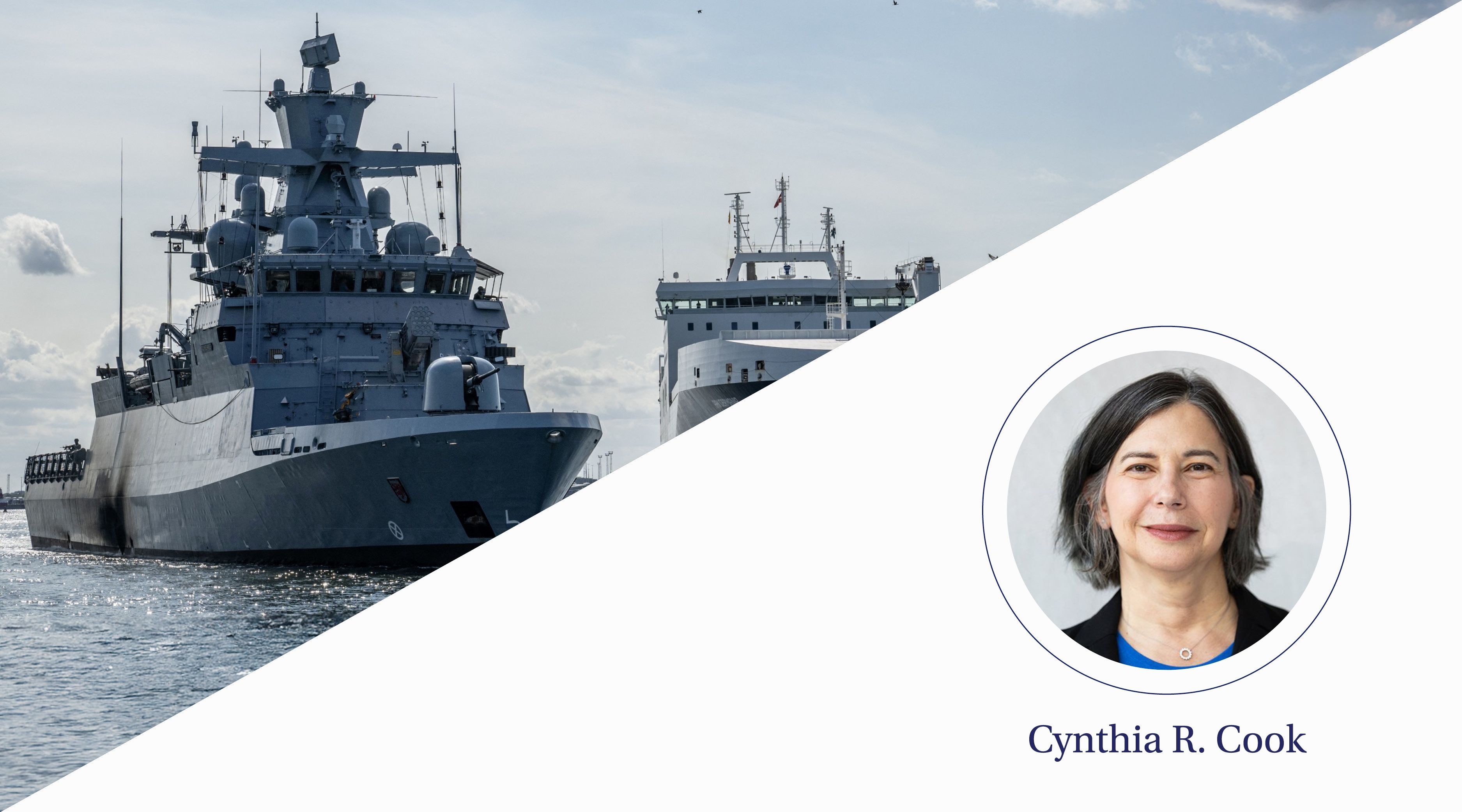 Two large metal ships sit on the water.